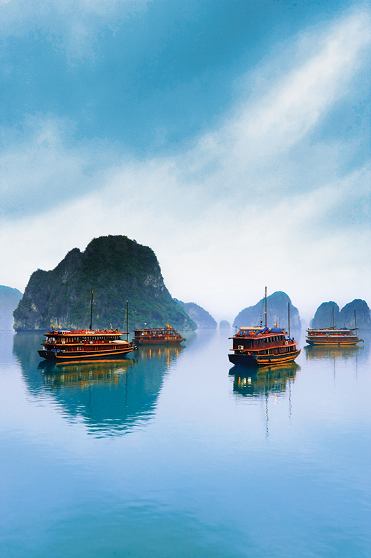  Four ships pass through Vietnam's vast Ha Long Bay. 