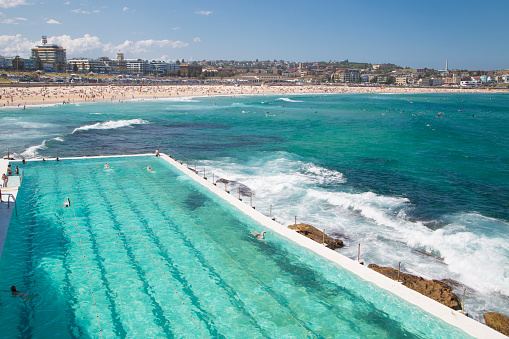 Ocean waves from Bondi Beach break on the pool's wall just feet away from swimming lanes.