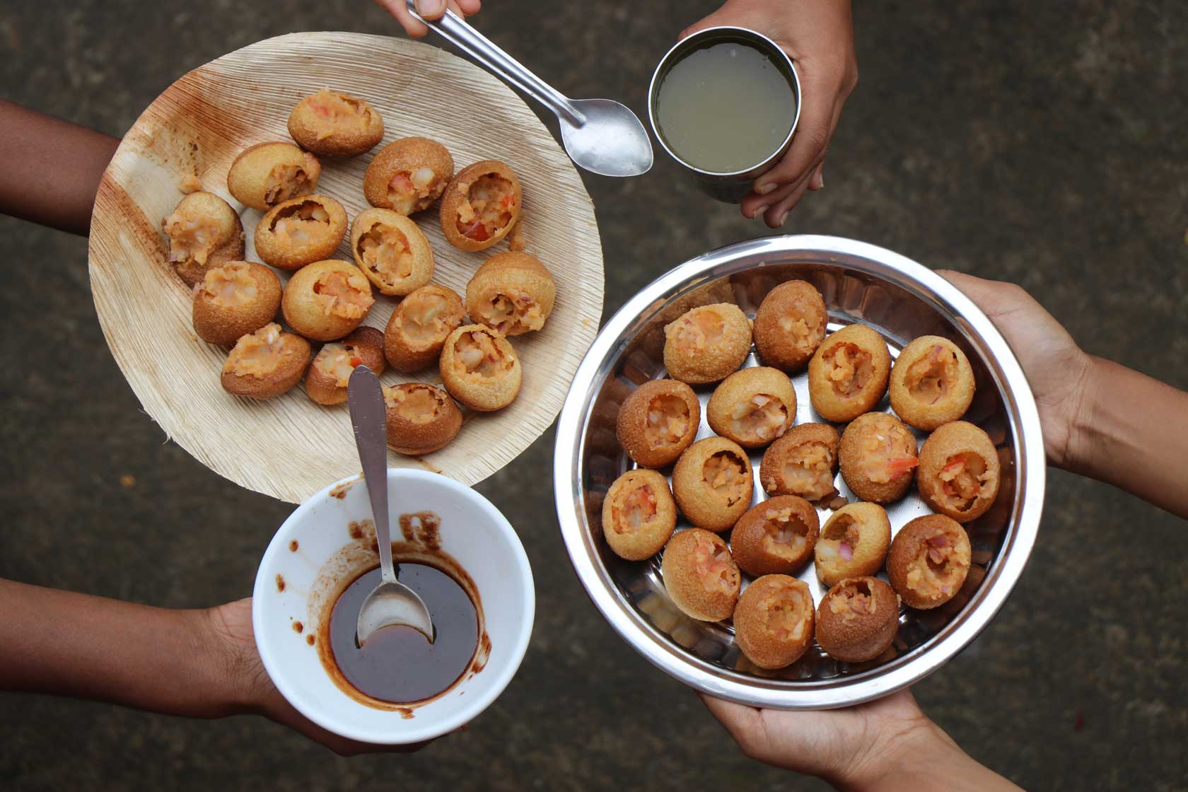 Panipuri filled with potatoes along with sauce
