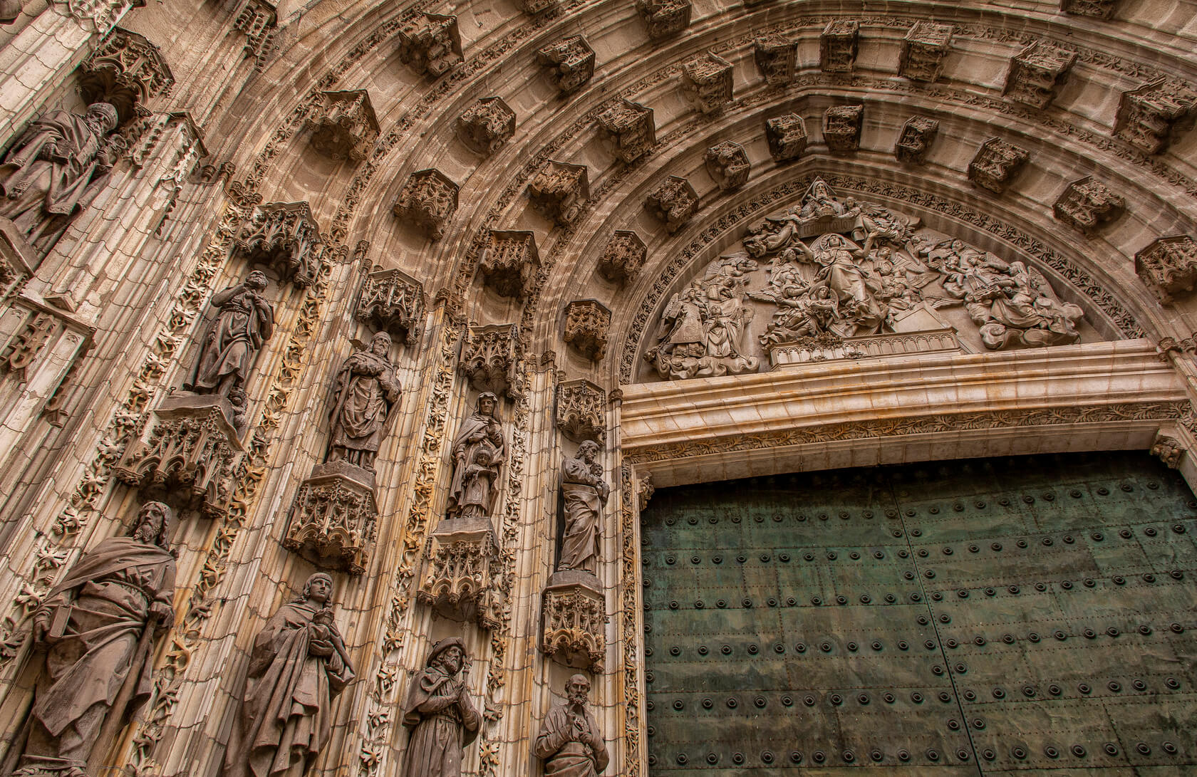 Seville, Andalusia, Spain. April 25, 2019. Almost a dozen access doors to the Cathedral of Seville. This one in particular, that of the Assumption is one of the most spectacular.