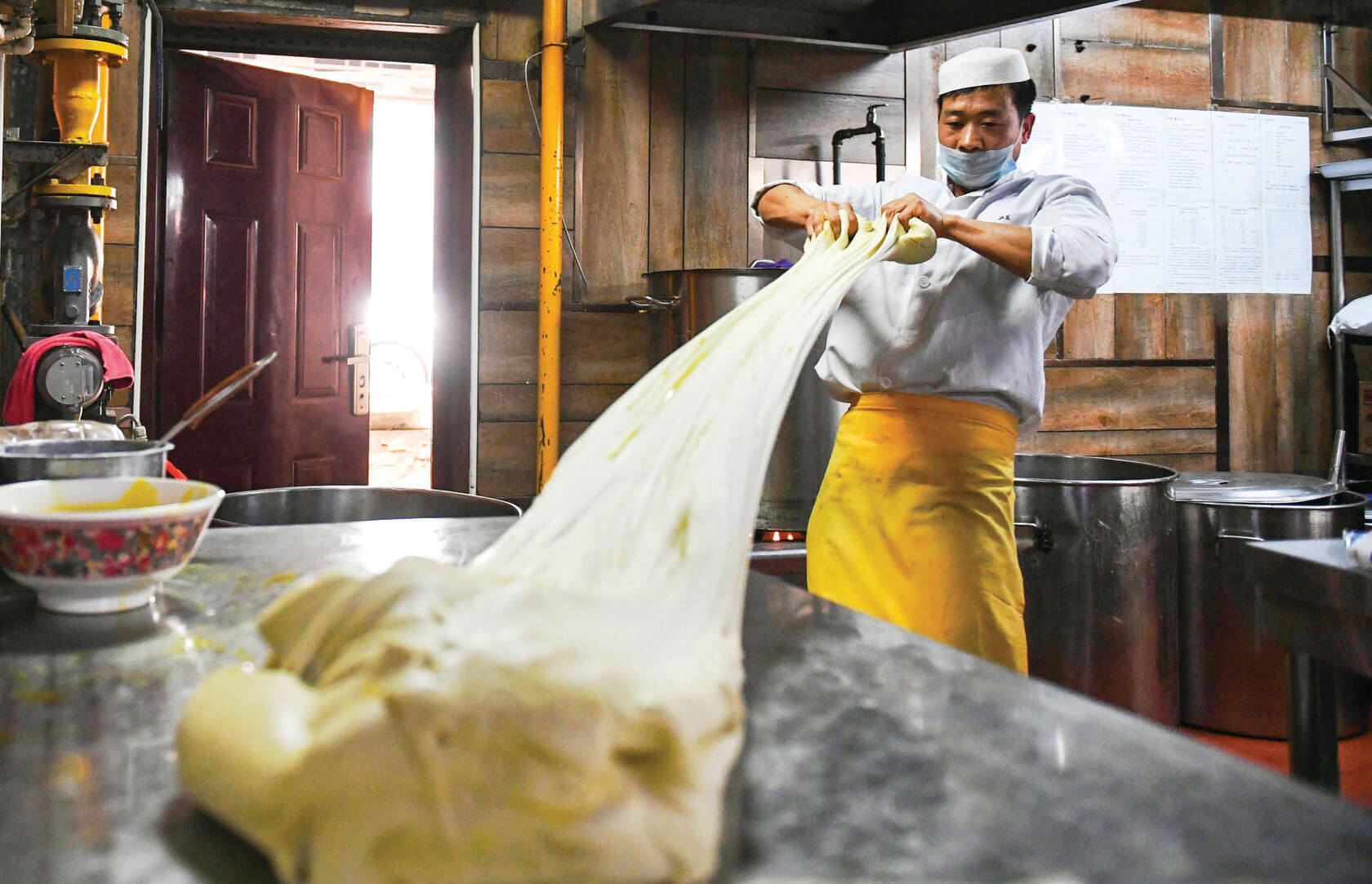 A chef pulling Lanzhou pulled noodle dough 