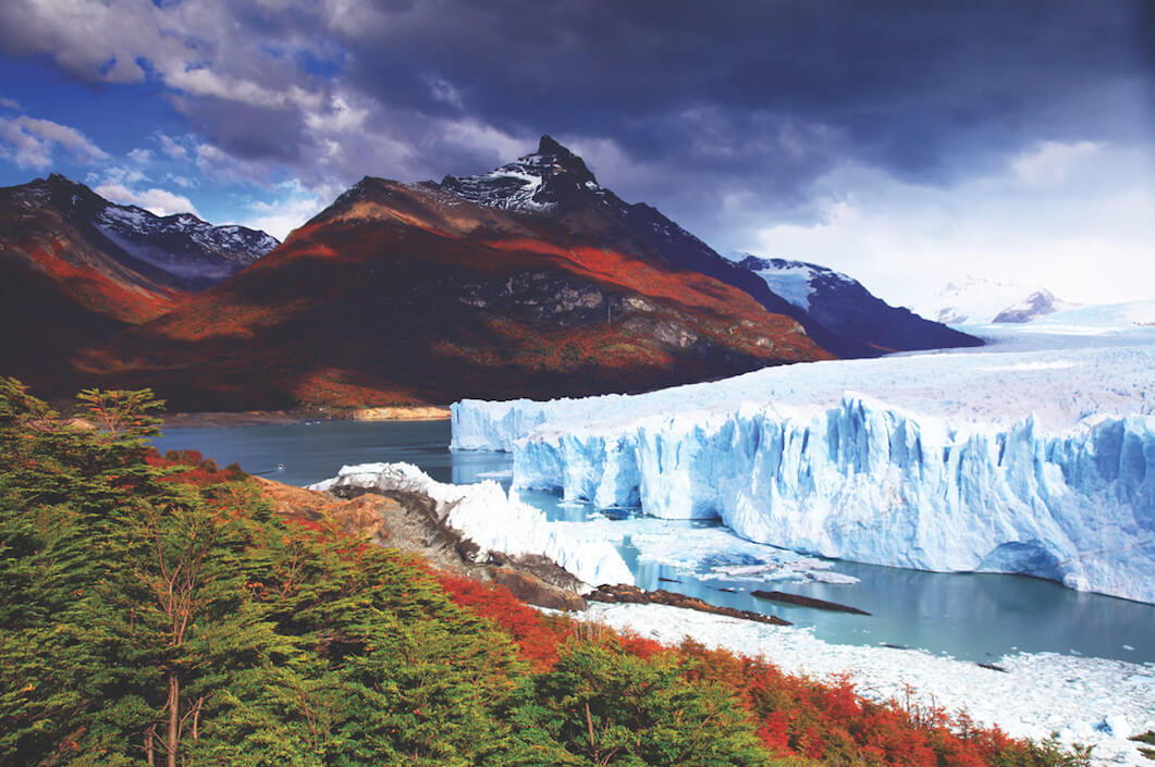 A landscape photo of the glacier Perrito Moreno in Patagonia with mountains in the background